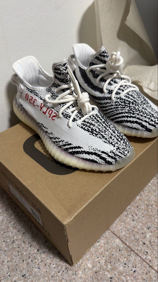 Authentic Adidas Yeezy Boost 350 V2 Zebra - US 9 (Category: Sneakers) located in Singapore. Submitted by glowing.skin (Listing ID 1434322917, Image 1). Description: - Adidas Yeezy Boost 350 V2 Zebra - Size: US 9 - Condition: Brand new, never worn - Includes original box, tags, and receipt - Perfect condition - Ready to ship.