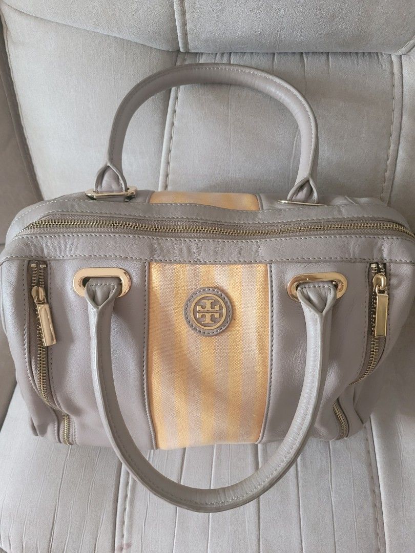 Authentic Tory Burch Satchel Handbag (Category: Luxury Bags & Wallets) located in Antipolo. Submitted by dlolin (Listing ID 1434387720, Image 3). Description: -Still useable Issue: Metal plate at the back got removed. Just have it fix in mister quickie. Tory Burch satchel handbag - Grey leather exterior - Gold-colored stripe detail - Double handles - Gold-toned hardware (zippers, logo) - Light-colored fabric lining - Made in China.