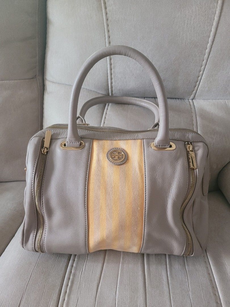Authentic Tory Burch Satchel Handbag (Category: Luxury Bags & Wallets) located in Antipolo. Submitted by dlolin (Listing ID 1434387720, Image 1). Description: -Still useable Issue: Metal plate at the back got removed. Just have it fix in mister quickie. Tory Burch satchel handbag - Grey leather exterior - Gold-colored stripe detail - Double handles - Gold-toned hardware (zippers, logo) - Light-colored fabric lining - Made in China.
