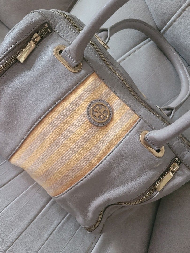 Authentic Tory Burch Satchel Handbag (Category: Luxury Bags & Wallets) located in Antipolo. Submitted by dlolin (Listing ID 1434387720, Image 2). Description: -Still useable Issue: Metal plate at the back got removed. Just have it fix in mister quickie. Tory Burch satchel handbag - Grey leather exterior - Gold-colored stripe detail - Double handles - Gold-toned hardware (zippers, logo) - Light-colored fabric lining - Made in China.