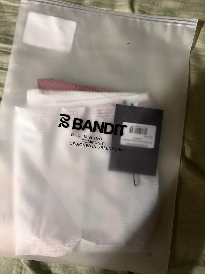 Bandit Running Tank Top - Vento Singlet Striated - Medium (Category: Activewear) located in Manila. Submitted by lumenos (Listing ID 1434377711, Image 2). Description: Bandit running singlet Size Medium Brand new Rfs- wrong size Pm me if interested QC area - White running tank top - Features a red "BANDIT" vertical stripe - Racerback design - Made from breathable and lightweight material - Ideal for running and athletic activities .