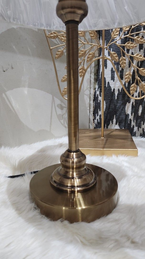 Brass Table Lamp with White Shade (Category: Lighting) located in Cavite. Submitted by geturs (Listing ID 1434254168, Image 2). Description: - Elegant brass table lamp - Features a white pleated lampshade - Detailed brass base and stem - Classic, sophisticated design - Ready to use with power cord NOTE: 1pair (2pcs) .
