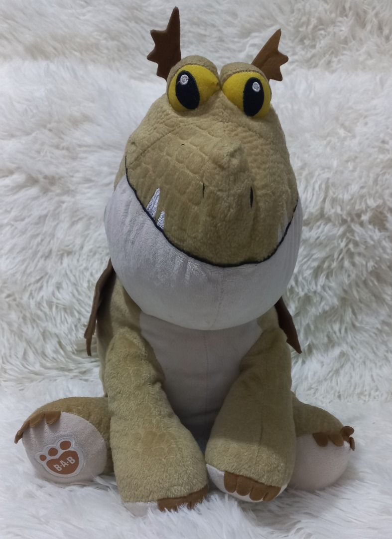 Build-A-Bear Toothless Plush (Category: Plushies & Soft Toys) located in Taguig. Submitted by phlercollections (Listing ID 1434341061, Image 1). Description: - Build-A-Bear Toothless plush - Unique tan and white color scheme - Large yellow eyes - Brown accents on head and wings - White belly - Friendly smile - Build-A-Bear logo on paw.