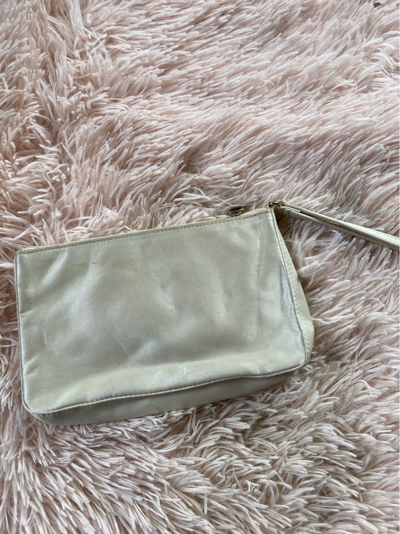 Bvlgari Clutch Bag (Category: Luxury Bags & Wallets) located in Manila. Submitted by kathhhhh236 (Listing ID 1434350895, Image 1). Description: - Bvlgari clutch bag in light cream color - Features a wrist strap - Gold-toned zipper with Bvlgari logo - Interior lined with Bvlgari logo fabric - Simple and stylish design.