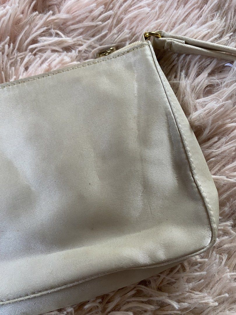 Bvlgari Clutch Bag (Category: Luxury Bags & Wallets) located in Manila. Submitted by kathhhhh236 (Listing ID 1434350895, Image 2). Description: - Bvlgari clutch bag in light cream color - Features a wrist strap - Gold-toned zipper with Bvlgari logo - Interior lined with Bvlgari logo fabric - Simple and stylish design.