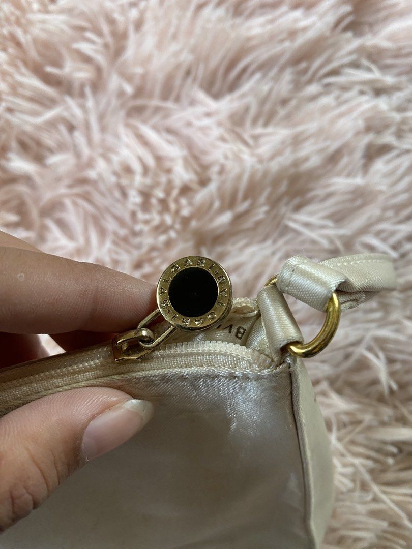 Bvlgari Clutch Bag (Category: Luxury Bags & Wallets) located in Manila. Submitted by kathhhhh236 (Listing ID 1434350895, Image 3). Description: - Bvlgari clutch bag in light cream color - Features a wrist strap - Gold-toned zipper with Bvlgari logo - Interior lined with Bvlgari logo fabric - Simple and stylish design.