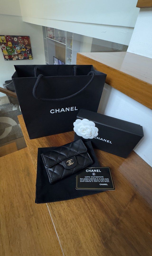 Chanel Card Holder (Category: Luxury Bags & Wallets) located in Plaridel. Submitted by kathtrene_alonzo39 (Listing ID 1433642288, Image 1). Description: -Unused - Authentic Chanel card holder - Classic black caviar design - Features the iconic CC logo - Includes original box - Comes with dust bag - Includes authenticity card - Chanel shopping bag included - Includes camellia flower.