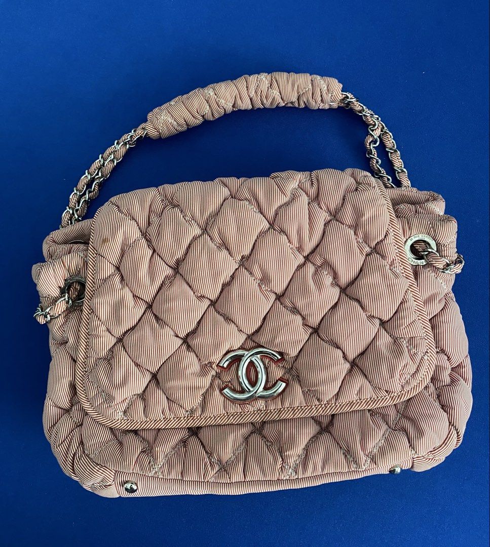 Chanel Quilted Handbag with Chain Strap Rare (Category: Luxury Bags & Wallets) located in Santa Rosa. Submitted by happydays__ (Listing ID 1434229061, Image 1). Description: - Authentic Chanel Bubble Bag - Light pink color with subtle striped pattern - Quilted design - Chain strap - Flap closure with Chanel logo - Shoulder bag - Silver-tone hardware - Soft, textured material Red inner lining Lightweight and super cute! RFS: Unloading Bag collecti