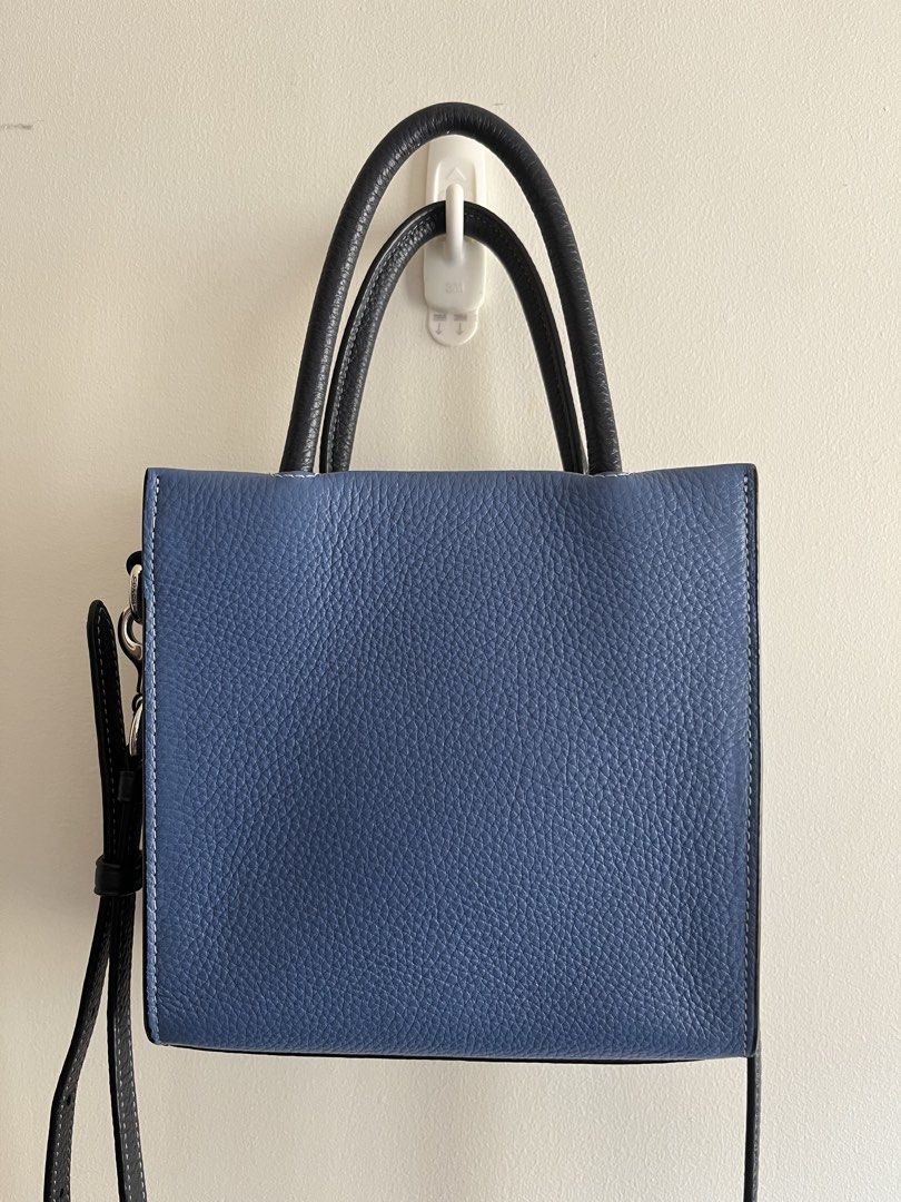 Coach Mini Cally Tote in Sky Blue Multi (Category: Luxury Bags & Wallets) located in Bacoor. Submitted by 2nds.pop (Listing ID 1434309422, Image 2). Description: Authentic original Please zoom in on photos to manage expectations. Hardware has coach logo Strap is too long for me so i added extra holes to make it shorter. .