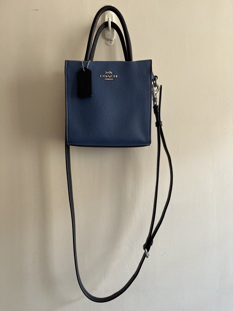 Coach Mini Cally Tote in Sky Blue Multi (Category: Luxury Bags & Wallets) located in Bacoor. Submitted by 2nds.pop (Listing ID 1434309422, Image 3). Description: Authentic original Please zoom in on photos to manage expectations. Hardware has coach logo Strap is too long for me so i added extra holes to make it shorter. .
