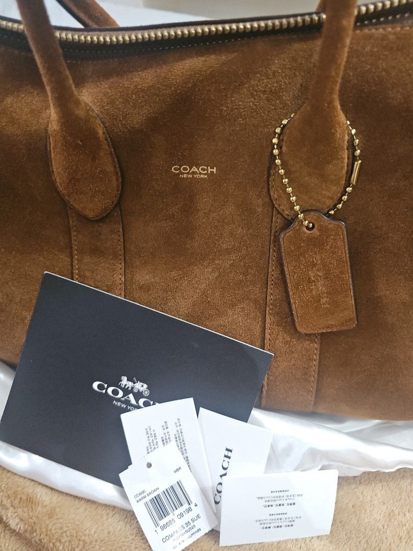 Coach Suede Compass 35 (Category: Luxury Bags & Wallets) located in Quezon City. Submitted by jaygee (Listing ID 1424573728, Image 1). Description: Authentic Coach Compass 35 Brown Suede With cards and dust bag Purchased in the US in Nov 2025 Retail store not outlet bag.