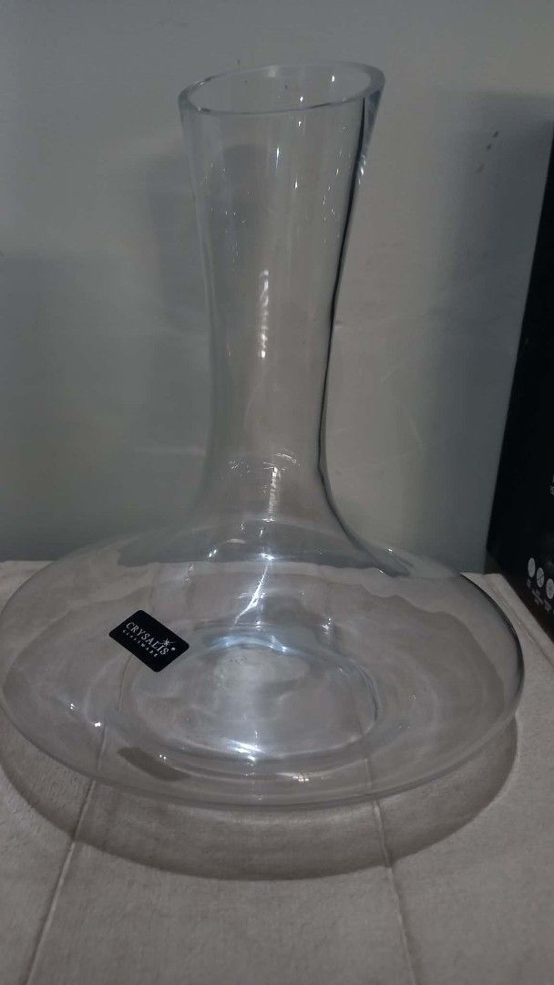 Crysalis Wine Decanter (Category: Other Kitchenware & Tableware) located in Cavite. Submitted by geturs (Listing ID 1434263908, Image 3). Description: - Crystalis wine decanter - Made of soda-lime glass - Features a wide base and pour spout - Designed to aerate wine for enhanced flavor and aroma - Comes in its original box - Ideal for home use or as a gift.