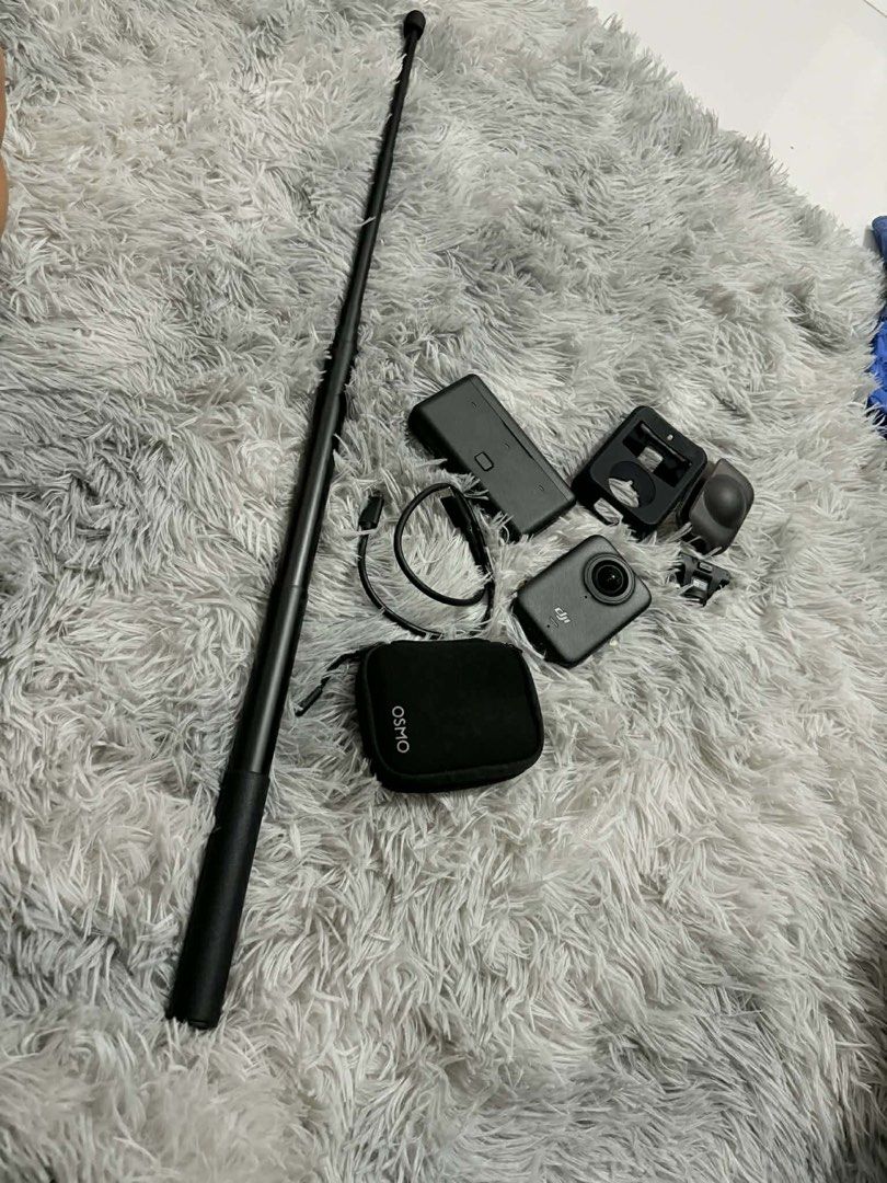DJI Osmo Action 360 Camera (Category: Cameras) located in Las Pinas. Submitted by anythinganywearols (Listing ID 1434261554, Image 3). Description: - DJI Osmo 360 camera included - Comes with protective case, charging case, and Osmo case - Includes a selfie stick and charging cable - Camera features a front screen and lens - Black Osmo case with zipper - Black, extendable selfie stick all accessories included + 2 free bats rfs: need funds bought 