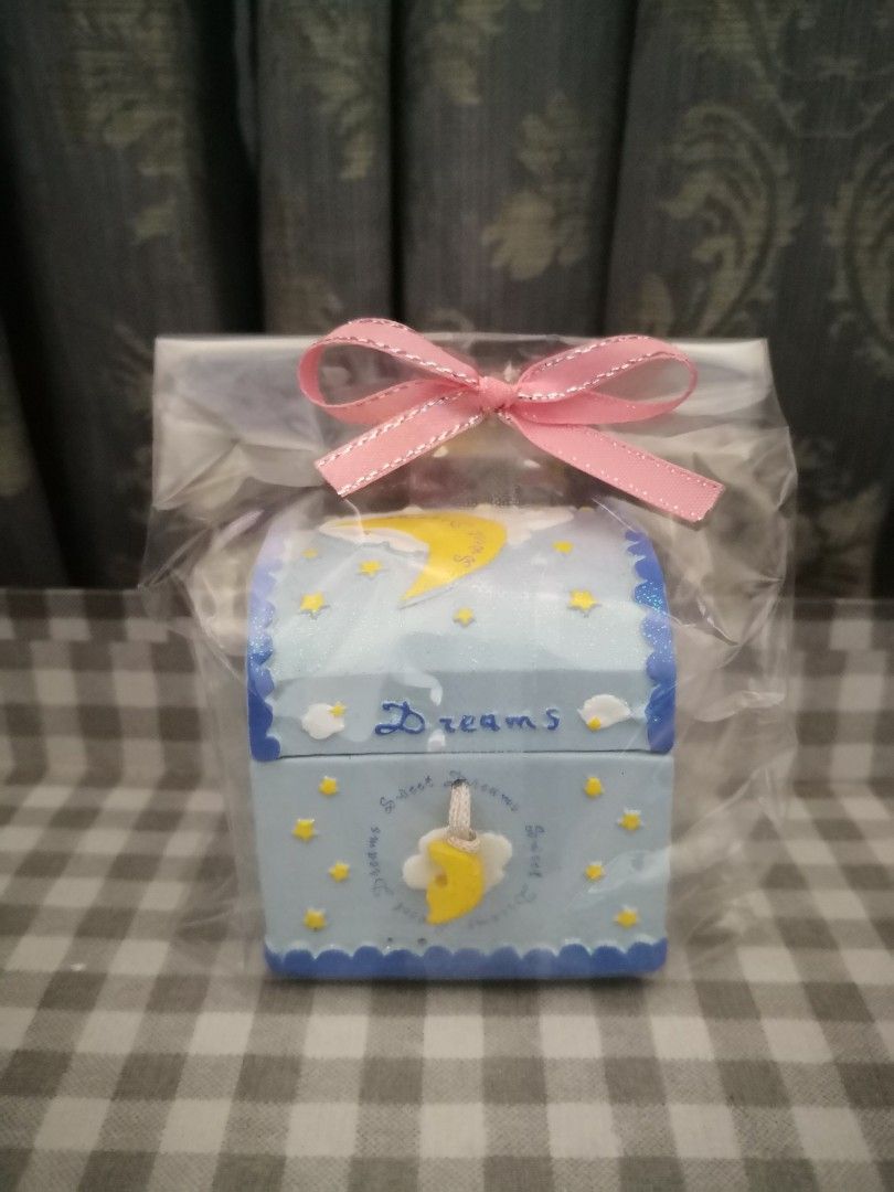 Dream Chest Ceramic Jewelry Box (Category: Storage Boxes & Baskets) located in Mandaluyong City. Submitted by ilovemyshop (Listing ID 1434229620, Image 1). Description: ❤️ Pretty collectible Ceramic jewelry box for free for a purchase of 2K up in my listings - Dreamy chest box design with moon and stars. - Features the word "Dreams". - Adorned with a delicate pink ribbon. - Ideal for storing small treasures or as decor. - Presented in clear plast