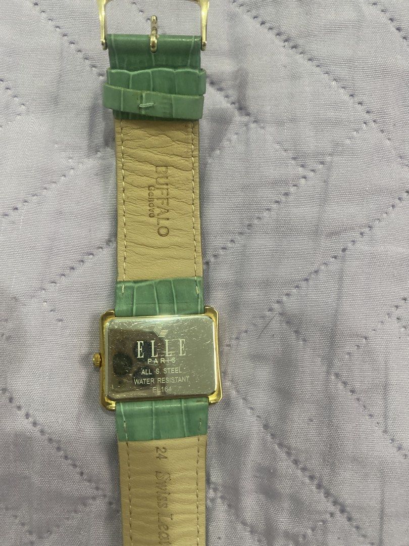 Elle Paris Watch with Green Strap (Category: Women's Watches) located in Manila. Submitted by scuba_diver25 (Listing ID 1434210757, Image 3). Description: - Authentic Elle Paris watch - Gold-toned rectangular case - Light green buffalo leather strap - Roman numeral hour markers - Textured watch face - Stainless steel back - Water resistant MOP: Gcash MOD: Lalamove / J&T.