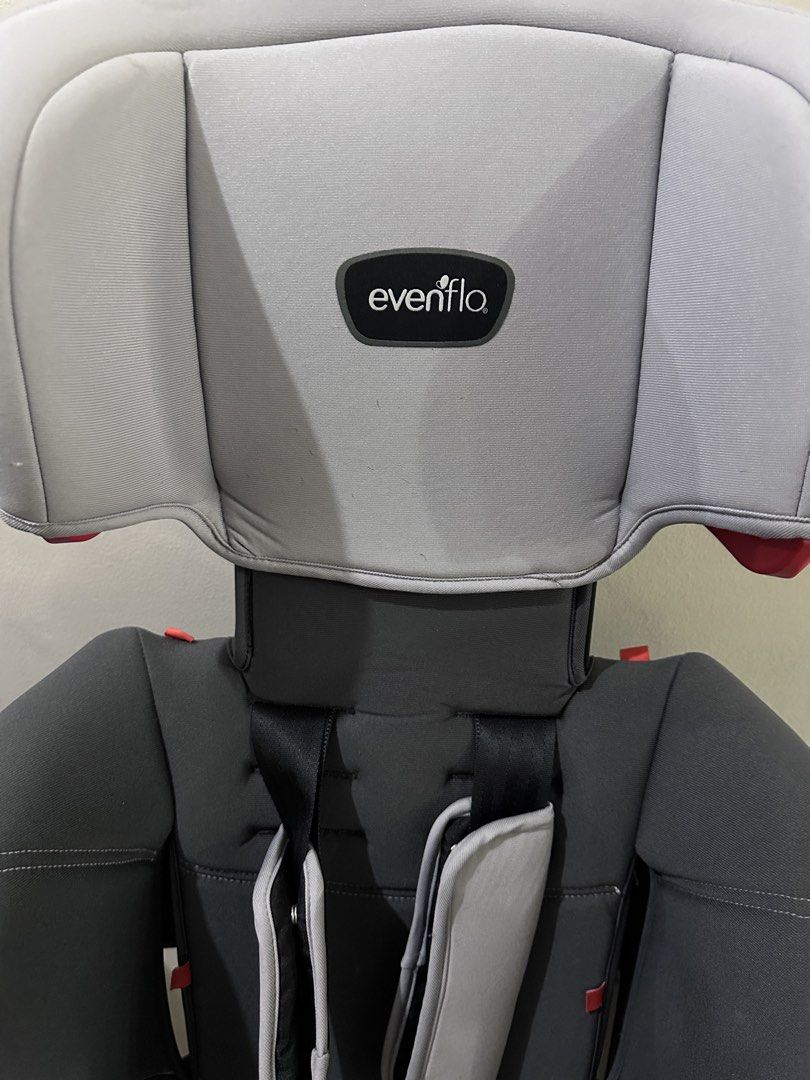 Evenflo Sutton Car Seat 3-in-1 (Category: Car Seats) located in Los Banos. Submitted by preloved-well-loved (Listing ID 1434199585, Image 3). Description: - Evenflo Sutton car seat - Color: Gray and black - Suitable for Group 2-3 children (15-36kg) - Includes headrest and harness system - Features a cup holder - Evenflo logo visible.