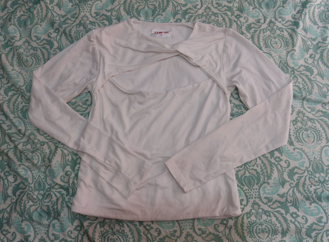 Fhilar Luna Cut Out Slim-Fitting Top (Category: Sleeveless) located in Manila. Submitted by lovedbydar (Listing ID 1434259108, Image 3). Description: - Fhilar long-sleeved top - White color - Unique chest cut-out design - Round neckline - Fitted silhouette - Size M - Lightweight fabric - Never been used - Has stains on the back.