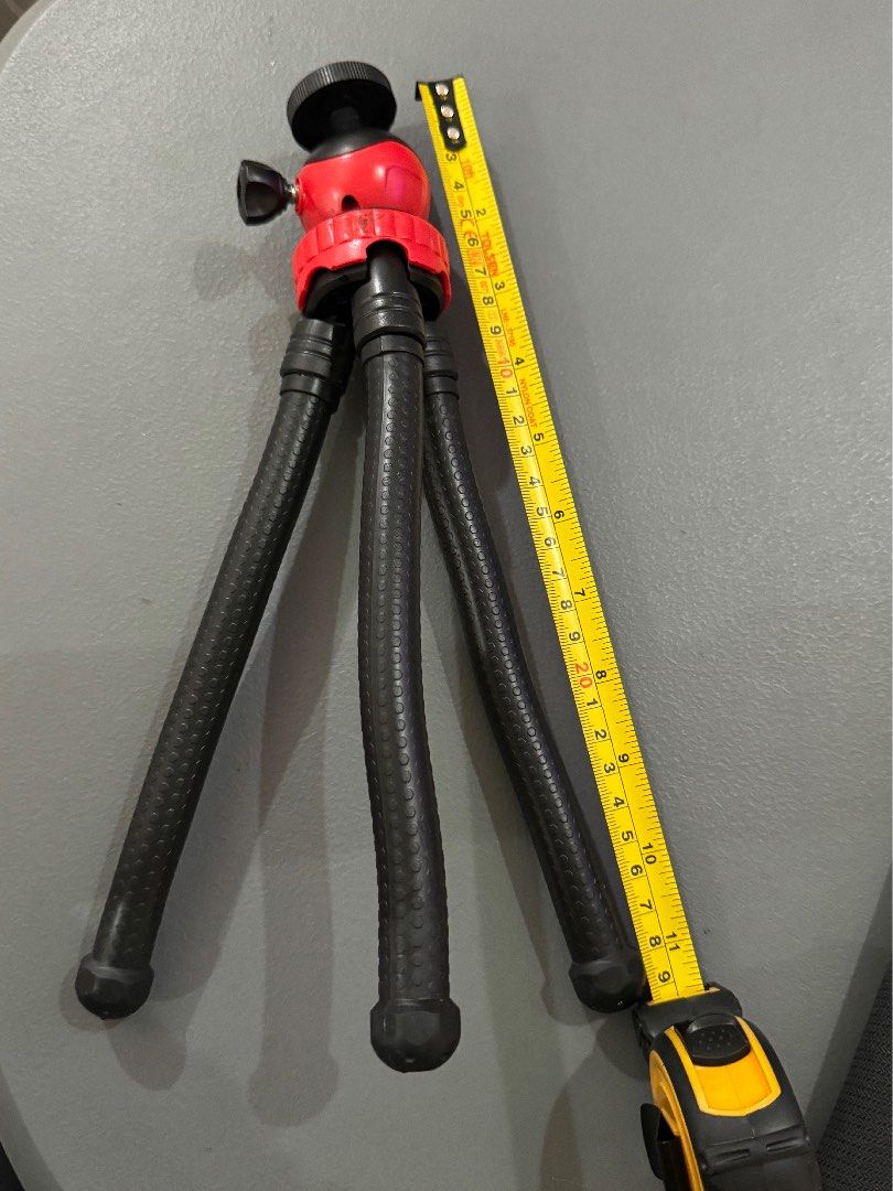 Flexible Tripod (Category: Tripods & Monopods) located in Taguig. Submitted by bljm_declutter (Listing ID 1434225611, Image 2). Description: - Mini tripod for stable photos and videos - Stylish red and black design - Adjustable legs for versatile positioning - Ball head for easy angle adjustments - Extends to approximately 20cm - Compatible with smartphones and small cameras.
