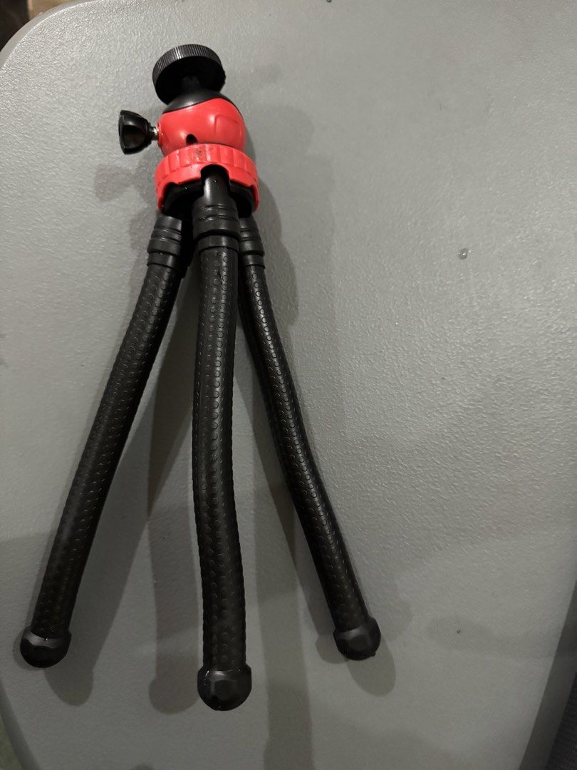 Flexible Tripod (Category: Tripods & Monopods) located in Taguig. Submitted by bljm_declutter (Listing ID 1434225611, Image 1). Description: - Mini tripod for stable photos and videos - Stylish red and black design - Adjustable legs for versatile positioning - Ball head for easy angle adjustments - Extends to approximately 20cm - Compatible with smartphones and small cameras.