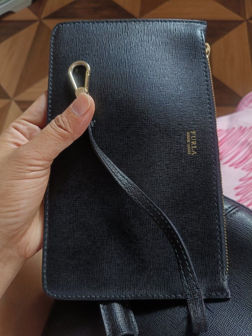 Furla Black Bucket Bag (Category: Luxury Bags & Wallets) located in Batangas. Submitted by lynmejlight (Listing ID 1434176653, Image 2). Description: Original FURLA made in Romania. Comes with pouch. Missing strap. Sobrang Ganda. Normal sign of used lang sa suede sa upper part. - Black Furla bucket bag - Drawstring closure.