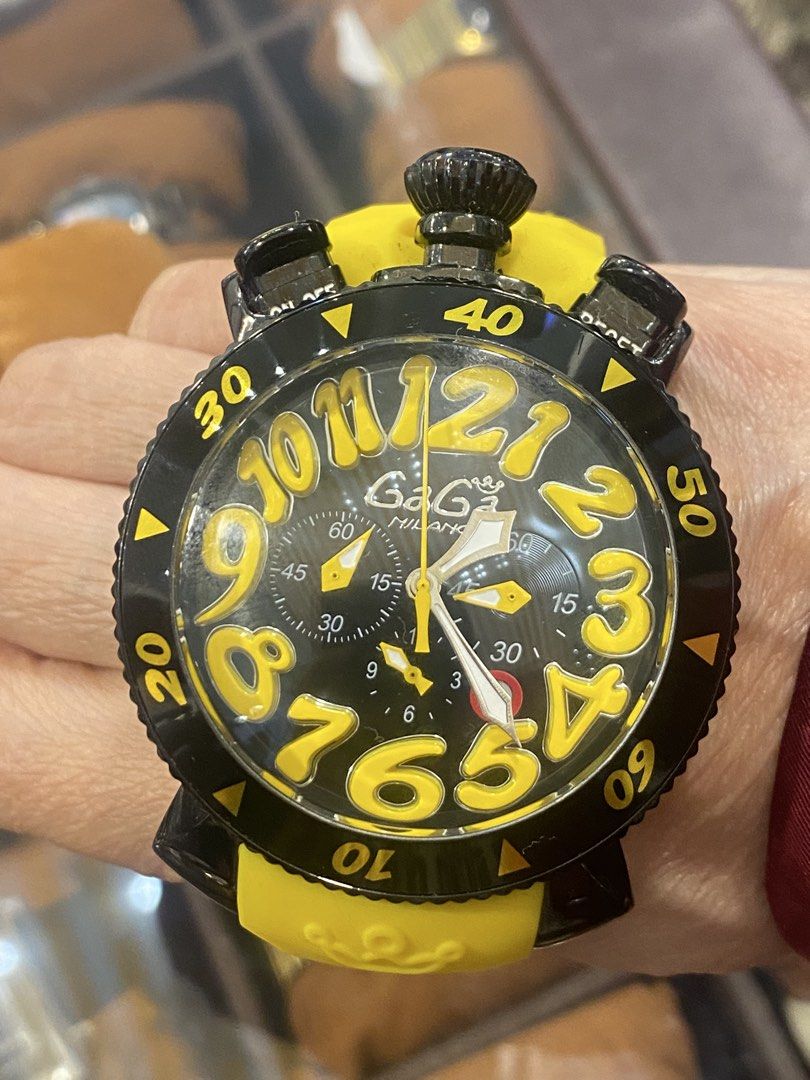GaGa Milano Chronograph Watch (Category: Luxury Watches) located in Manila. Submitted by roseluxuryitems (Listing ID 1434225828, Image 1). Description: - GaGa Milano watch - Black and yellow design - Chronograph function - Yellow strap - Large yellow numerals - Multiple sub-dials - Marked with "MILANO ITALY" and GaGa Milano logo - GaGa Milano logo engraved on strap.