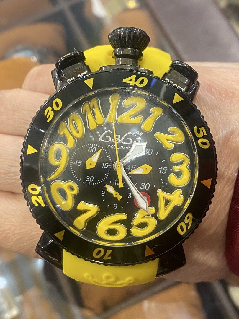 GaGa Milano Chronograph Watch (Category: Luxury Watches) located in Manila. Submitted by roseluxuryitems (Listing ID 1434225828, Image 2). Description: - GaGa Milano watch - Black and yellow design - Chronograph function - Yellow strap - Large yellow numerals - Multiple sub-dials - Marked with "MILANO ITALY" and GaGa Milano logo - GaGa Milano logo engraved on strap.