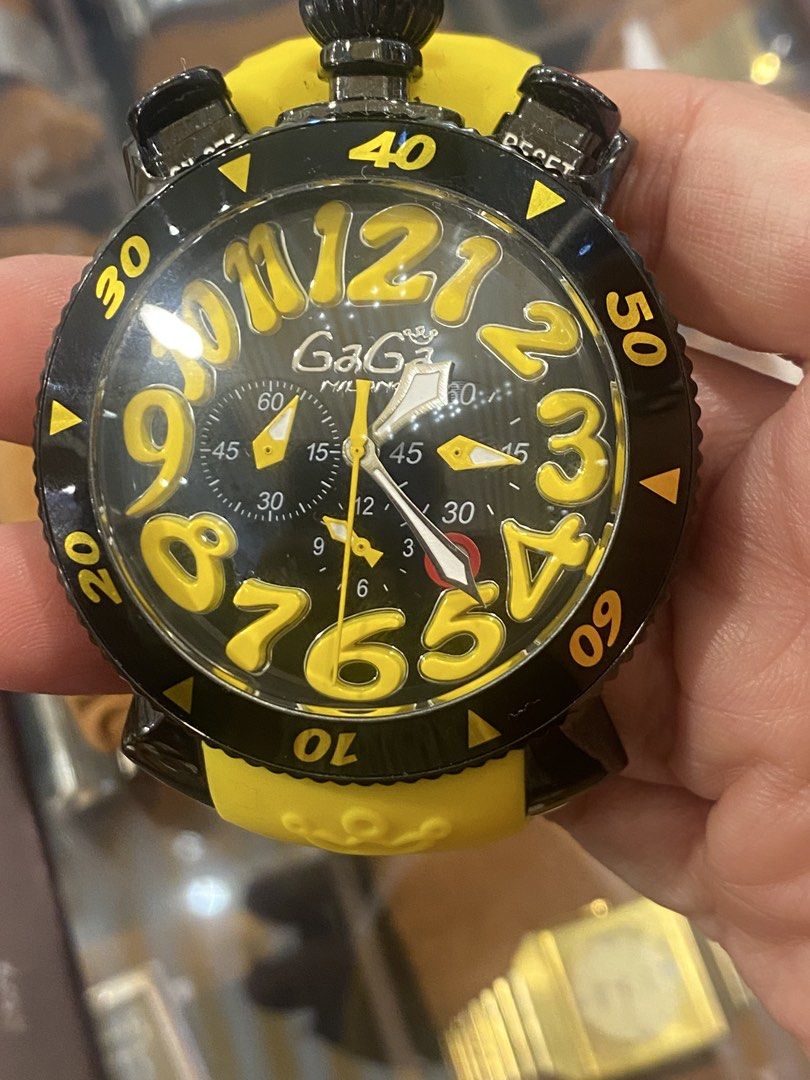 GaGa Milano Chronograph Watch (Category: Luxury Watches) located in Manila. Submitted by roseluxuryitems (Listing ID 1434225828, Image 3). Description: - GaGa Milano watch - Black and yellow design - Chronograph function - Yellow strap - Large yellow numerals - Multiple sub-dials - Marked with "MILANO ITALY" and GaGa Milano logo - GaGa Milano logo engraved on strap.