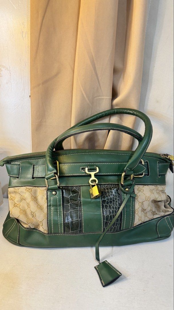 Green Handbag with Gold Accents (Category: Luxury Bags & Wallets) located in Manila. Submitted by ynilleryzc (Listing ID 1434338579, Image 1). Description: - Green handbag - Mixed materials - Gold-colored hardware - Top handle design - Zip closure - Decorative tag - Unique design with varied textures and patterns.
