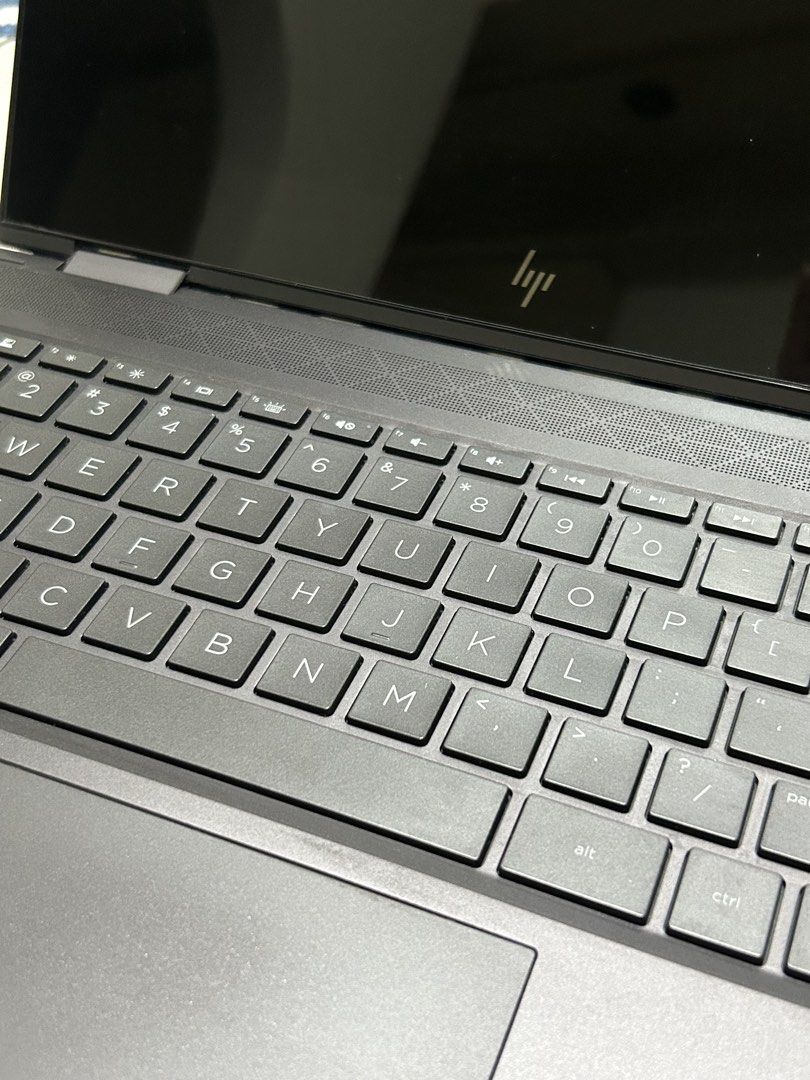 HP Envy x360 Convertible Laptop (Category: Laptops & Notebooks) located in Quezon City. Submitted by charlieee3_ (Listing ID 1434303199, Image 2). Description: HP Envy x360 convertible laptop with Bang & Olufsen speakers. Features an AMD Ryzen 7 processor and Radeon Vega Graphics. Includes multiple ports such as USB, SD card slot, and USB-C. The laptop has a sleek, dark gray finish and a full keyboard. - used for school only - 8GB RAM - with scre