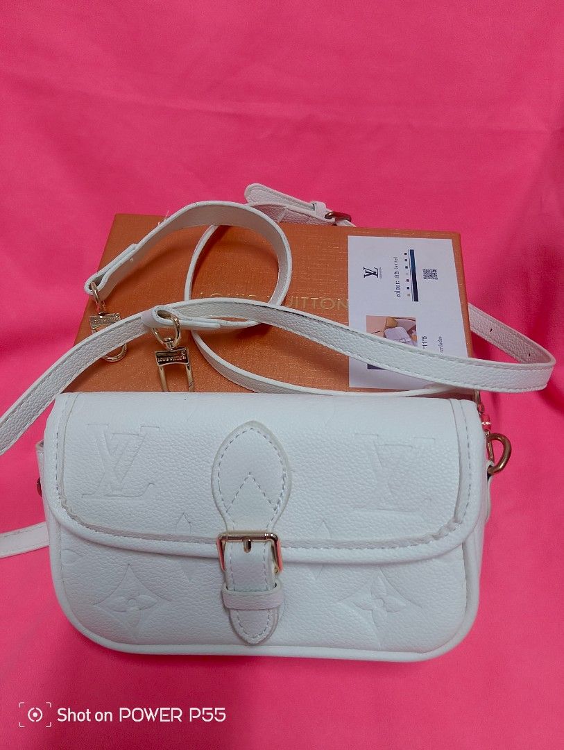 Louis Vuitton White Embossed Crossbody Bag (Category: Cross-body Bags) located in Binan City. Submitted by stuffshop29 (Listing ID 1434237489, Image 1). Description: - Louis Vuitton Crossbody Bag - Embossed pattern - Color: White - Dimensions: 19*11*5 - Buckle closure - Detachable strap - Includes original box and dust bag - Interior: Black leather tag with Louis Vuitton logo.