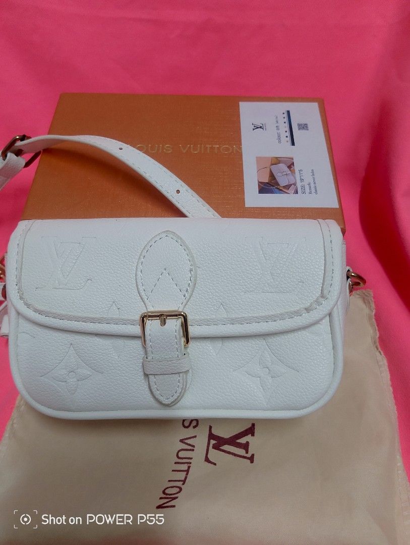 Louis Vuitton White Embossed Crossbody Bag (Category: Cross-body Bags) located in Binan City. Submitted by stuffshop29 (Listing ID 1434237489, Image 2). Description: - Louis Vuitton Crossbody Bag - Embossed pattern - Color: White - Dimensions: 19*11*5 - Buckle closure - Detachable strap - Includes original box and dust bag - Interior: Black leather tag with Louis Vuitton logo.