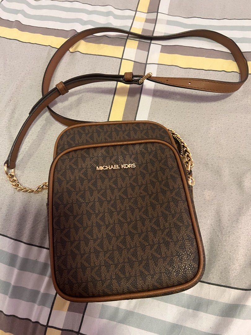 Michael Kors Brown Crossbody Bag (Category: Cross-body Bags) located in Manila. Submitted by mrac10 (Listing ID 1434202450, Image 2). Description: - Michael Kors crossbody bag - Brown monogram pattern - Gold chain and adjustable brown strap - Zip closure - Interior pocket - Michael Kors branded lining - Gold zipper pull with Michael Kors logo - authentic Given as gift .