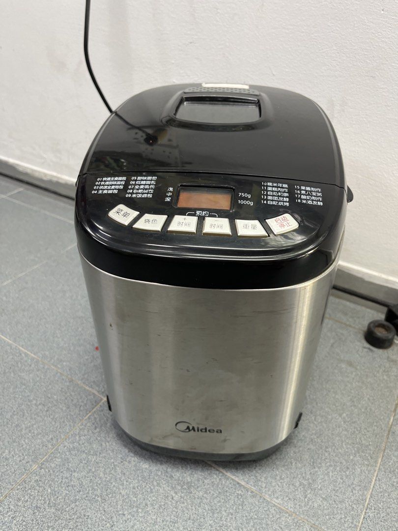 Midea Bread Maker (Category: Breadmakers) located in Singapore. Submitted by cmtc-sg (Listing ID 1434232356, Image 1). Description: - Midea bread maker - Includes all accessories (measuring cups, hook, storage container) - Multiple settings for different bread types - Stainless steel exterior - note that selection buttons are in mandarin .