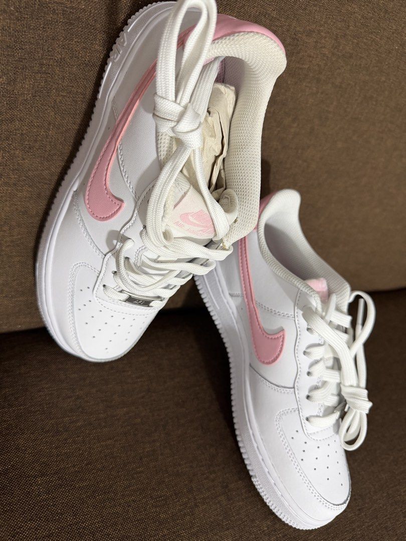 Nike Air Force 1 White Pink (Category: Sneakers) located in Makati City. Submitted by sunsetk (Listing ID 1434236818, Image 3). Description: - Nike Air Force 1 sneakers - 23.5 cm / EU 37 / US 6 / UK 4.5 - White with pink accents - Iconic pink Nike swoosh - Includes original box - White laces - White sole - Unworn condition Makati pick up or delivery.