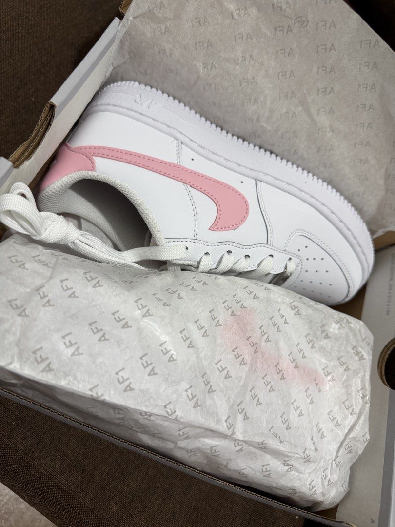 Nike Air Force 1 White Pink (Category: Sneakers) located in Makati City. Submitted by sunsetk (Listing ID 1434236818, Image 2). Description: - Nike Air Force 1 sneakers - 23.5 cm / EU 37 / US 6 / UK 4.5 - White with pink accents - Iconic pink Nike swoosh - Includes original box - White laces - White sole - Unworn condition Makati pick up or delivery.