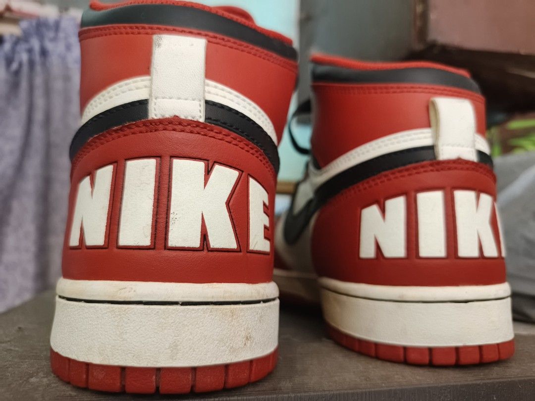 Nike High-Top Sneakers Red White Black (Category: Sneakers) located in Quezon City. Submitted by SM0SHY (Listing ID 1434192326, Image 2). Description: - Classic Nike high-top sneakers - Color scheme: Red, white, and black - Features the iconic Nike swoosh - Bold "NIKE" branding on the heel - Black laces - White midsole - Design includes red and white panels with black ankle accent -Size US 10 | UK 9 |EUR 44 |CM 28.