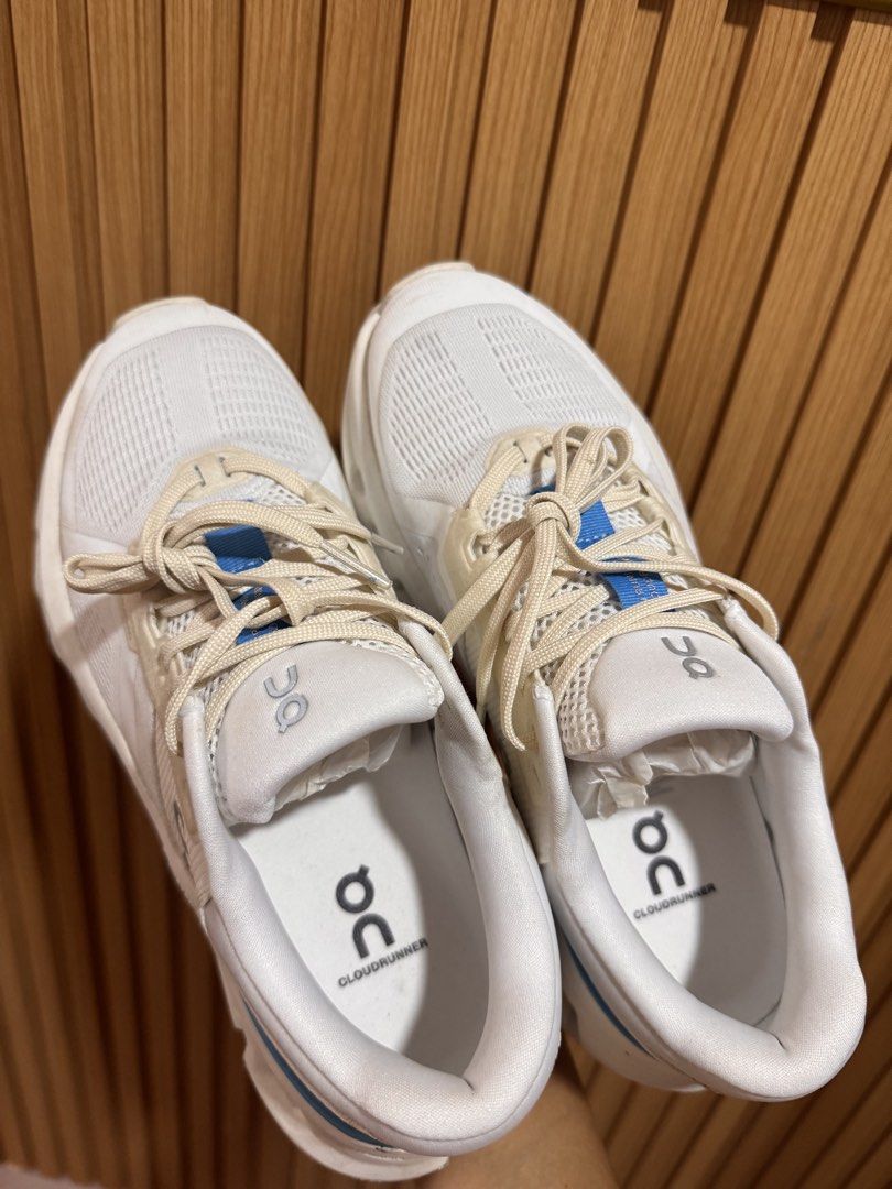 On Cloudrunner Horizon Running Shoes - White (Category: Sneakers) located in Silay City. Submitted by declutterwithm3 (Listing ID 1434381165, Image 2). Description: Used only twice. Need to size down. On Cloudrunner Horizon running shoes in white. Features a breathable mesh upper with blue accents. The shoes have a CloudTec sole for cushioning and support. The size is US W7, EU 38, UK 5, JP 24. The shoes have the On logo on the side and Cloudrunn