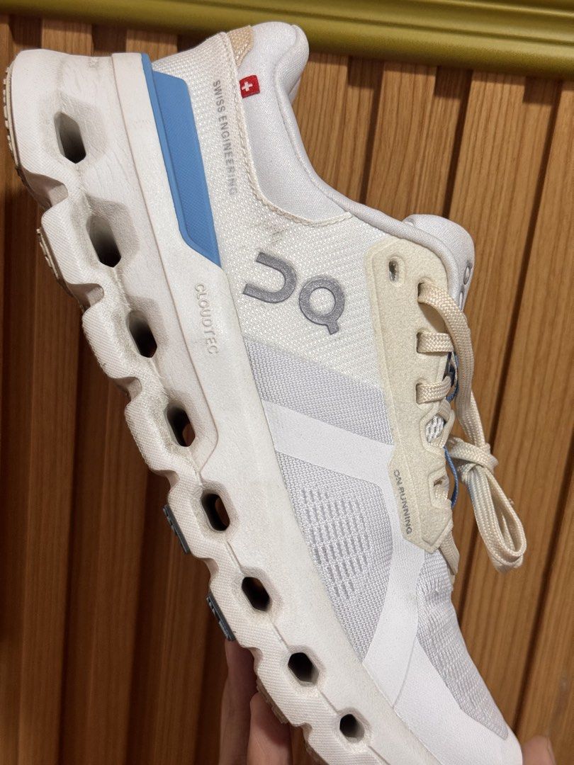 On Cloudrunner Horizon Running Shoes - White (Category: Sneakers) located in Silay City. Submitted by declutterwithm3 (Listing ID 1434381165, Image 3). Description: Used only twice. Need to size down. On Cloudrunner Horizon running shoes in white. Features a breathable mesh upper with blue accents. The shoes have a CloudTec sole for cushioning and support. The size is US W7, EU 38, UK 5, JP 24. The shoes have the On logo on the side and Cloudrunn