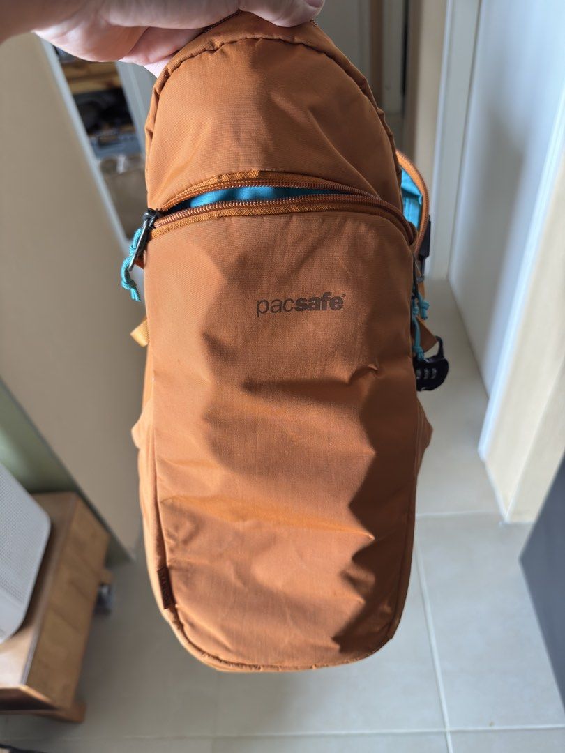 Pacsafe 12L Sling Backpack (Category: Backpacks) located in Pasay City. Submitted by leo665555 (Listing ID 1434240874, Image 1). Description: - Pacsafe 12L Sling Backpack - Anti-theft features: lockable zippers, slash-resistant material - 3-point carry system, ambidextrous - 12L capacity - 11 inches wide - Color: Orange exterior, Blue interior - Padded back for comfort.