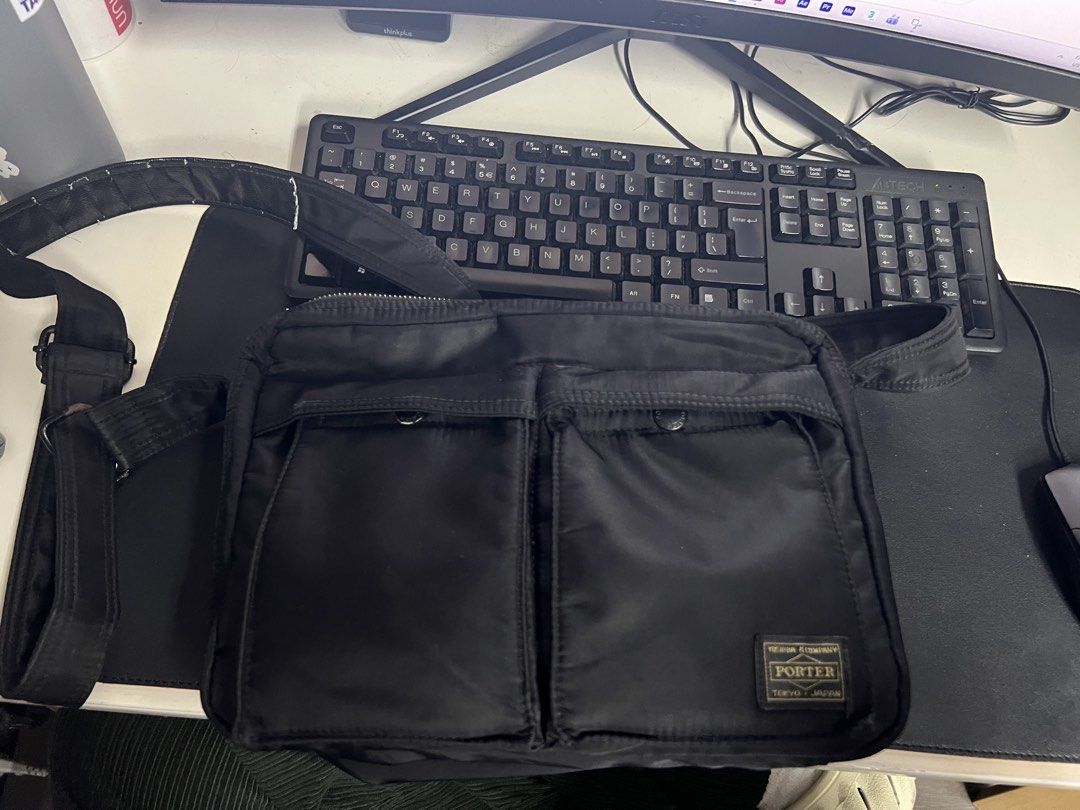 Porter Yoshida & Co. Shoulder Bag (Category: Luxury Bags & Wallets) located in Manila. Submitted by mark_decluttering (Listing ID 1434215986, Image 1). Description: - Authentic Porter Yoshida & Co. shoulder bag - Classic black color - Multiple compartments for organization - Two front pockets - Interior with clear pockets and orange lining - Secure zipper closure - Includes Porter tag - Made in Japan Last price posted.