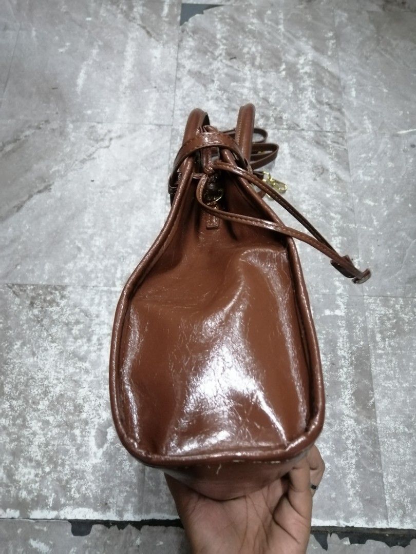 Prada Bonnie Large Brown Leather Handbag (Category: Luxury Bags & Wallets) located in Baguio. Submitted by brandeditems16 (Listing ID 1434384434, Image 3). Description: - Authentic Prada handbag - Rich brown color - Top handle and detachable shoulder strap - Interior zip closure - Made in Italy - Classic shape - Gold-tone hardware - Prada logo on front -Dustbag inclusion only .
