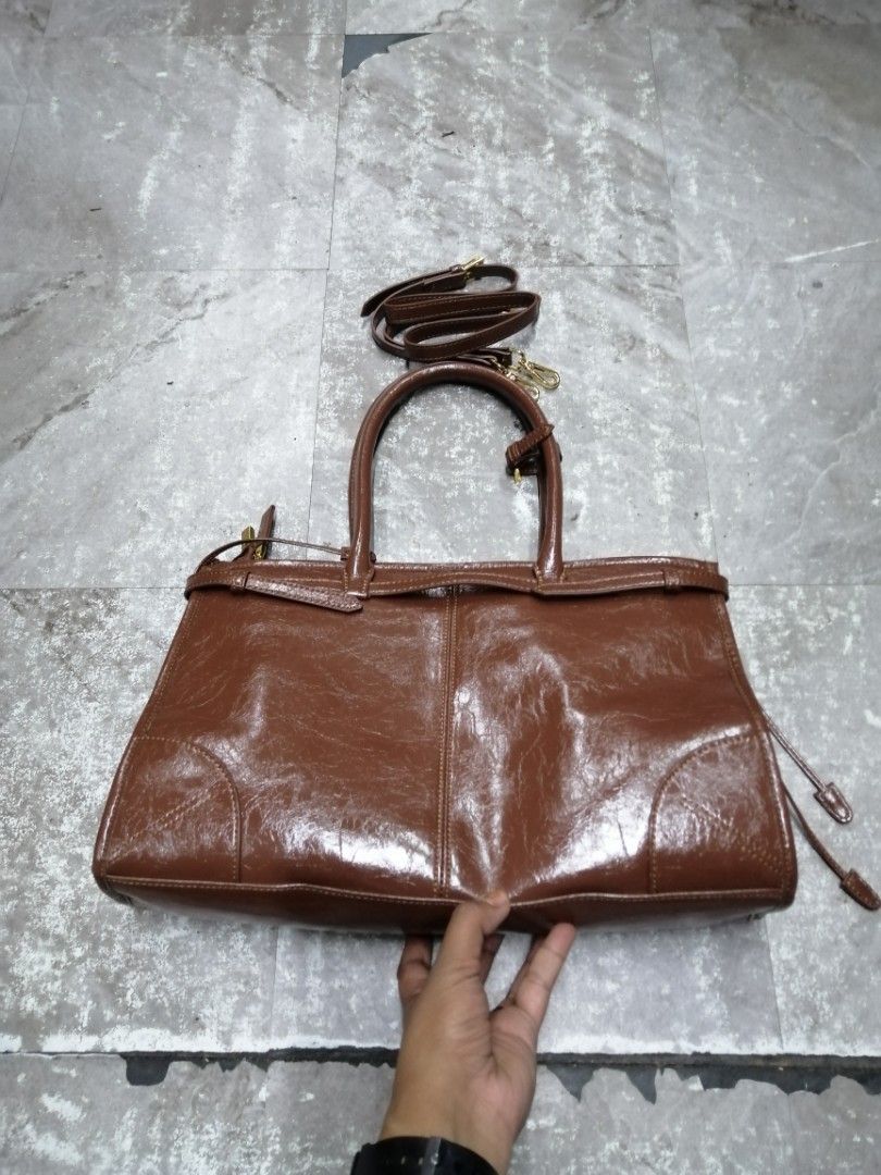 Prada Bonnie Large Brown Leather Handbag (Category: Luxury Bags & Wallets) located in Baguio. Submitted by brandeditems16 (Listing ID 1434384434, Image 2). Description: - Authentic Prada handbag - Rich brown color - Top handle and detachable shoulder strap - Interior zip closure - Made in Italy - Classic shape - Gold-tone hardware - Prada logo on front -Dustbag inclusion only .