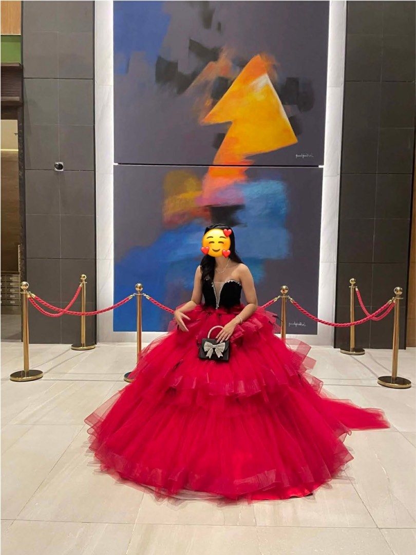 Red Ball Gown with Black Bodice (Category: Evening dresses & gowns) located in General Trias. Submitted by jd_15 (Listing ID 1434216312, Image 2). Description: Spent 45k for the gown - Elegant red ball gown - Strapless black bodice - Voluminous, layered tulle skirt - Includes a small black handbag with bow detail - Unique black accent design on the back.
