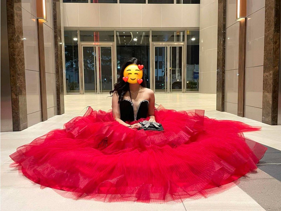 Red Ball Gown with Black Bodice (Category: Evening dresses & gowns) located in General Trias. Submitted by jd_15 (Listing ID 1434216312, Image 1). Description: Spent 45k for the gown - Elegant red ball gown - Strapless black bodice - Voluminous, layered tulle skirt - Includes a small black handbag with bow detail - Unique black accent design on the back.