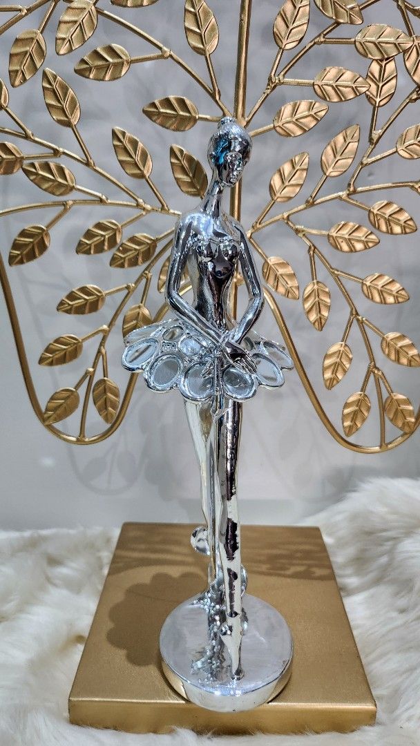 Silver Ballerina Figurine with Gold Base (Category: Figurines & Statues) located in Cavite. Submitted by geturs (Listing ID 1434260920, Image 1). Description: - Silver ballerina figurine - Clear glass-like element on base - Approximately 20cm long.