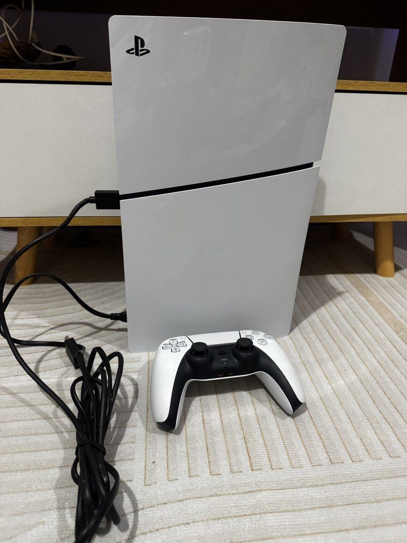 Sony PlayStation5 Slim PS5 (Category: PlayStation) located in Taguig. Submitted by mjpd_shop (Listing ID 1434190139, Image 2). Description: - with box - Bought August 2024 -White Sony PlayStation 5 console - Matching white controller included - Standard controller button layout with touchpad - Features the PlayStation logo - Includes power cable - Sleek, modern design - Console shown from multiple angles - Issue: Blue Light of Death (the console 