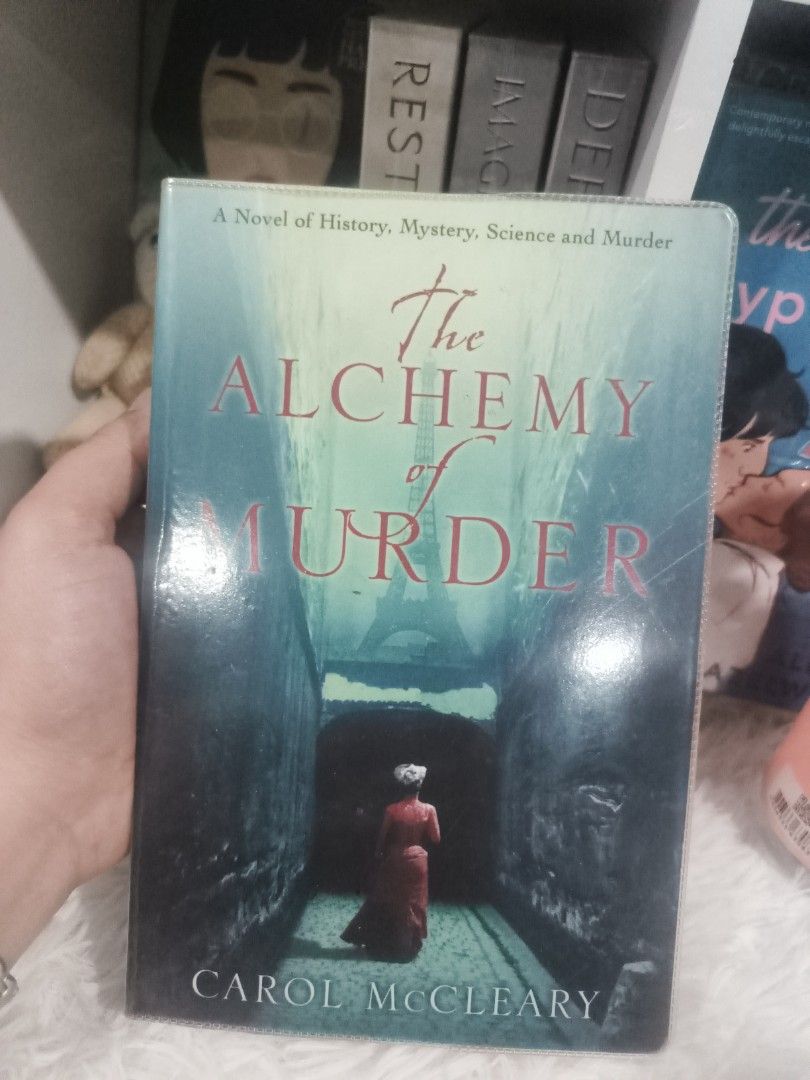The Alchemy of Murder by Carol McCleary (Category: Storybooks) located in Cabuyao City. Submitted by chaptersandwonders143 (Listing ID 1434271577, Image 1). Description: - Title: The Alchemy of Murder - Author: Carol McCleary - Genre: Historical Mystery - Publisher: Hodder - Cover: Blue and white - Language: English - Condition: Good.