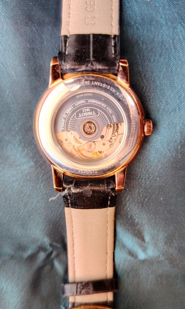 Tissot Rose Gold Powermatic (Category: Luxury Watches) located in Minglanilla. Submitted by peteraddatz (Listing ID 1434197285, Image 2). Description: - Rose GoldTissot watch with a white dial - Roman numeral hour markers - Date display at 3 o'clock - Rose gold-plated case - Black leather strap - 'Powermatic 80' dial issue : slight scratch above bezel but still very presentable and elegant watch as scratch is barely noticeable German owner well t