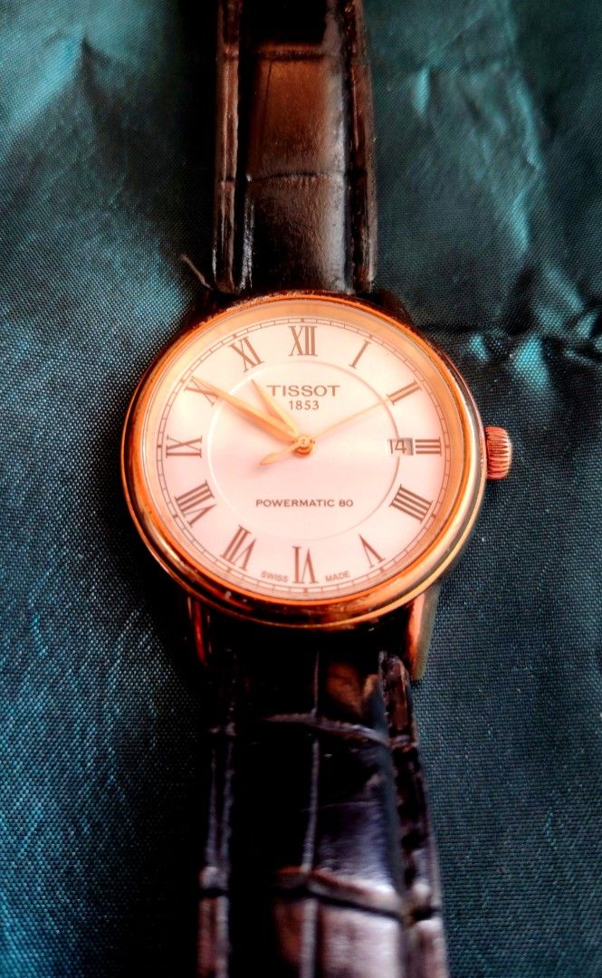 Tissot Rose Gold Powermatic (Category: Luxury Watches) located in Minglanilla. Submitted by peteraddatz (Listing ID 1434197285, Image 1). Description: - Rose GoldTissot watch with a white dial - Roman numeral hour markers - Date display at 3 o'clock - Rose gold-plated case - Black leather strap - 'Powermatic 80' dial issue : slight scratch above bezel but still very presentable and elegant watch as scratch is barely noticeable German owner well t