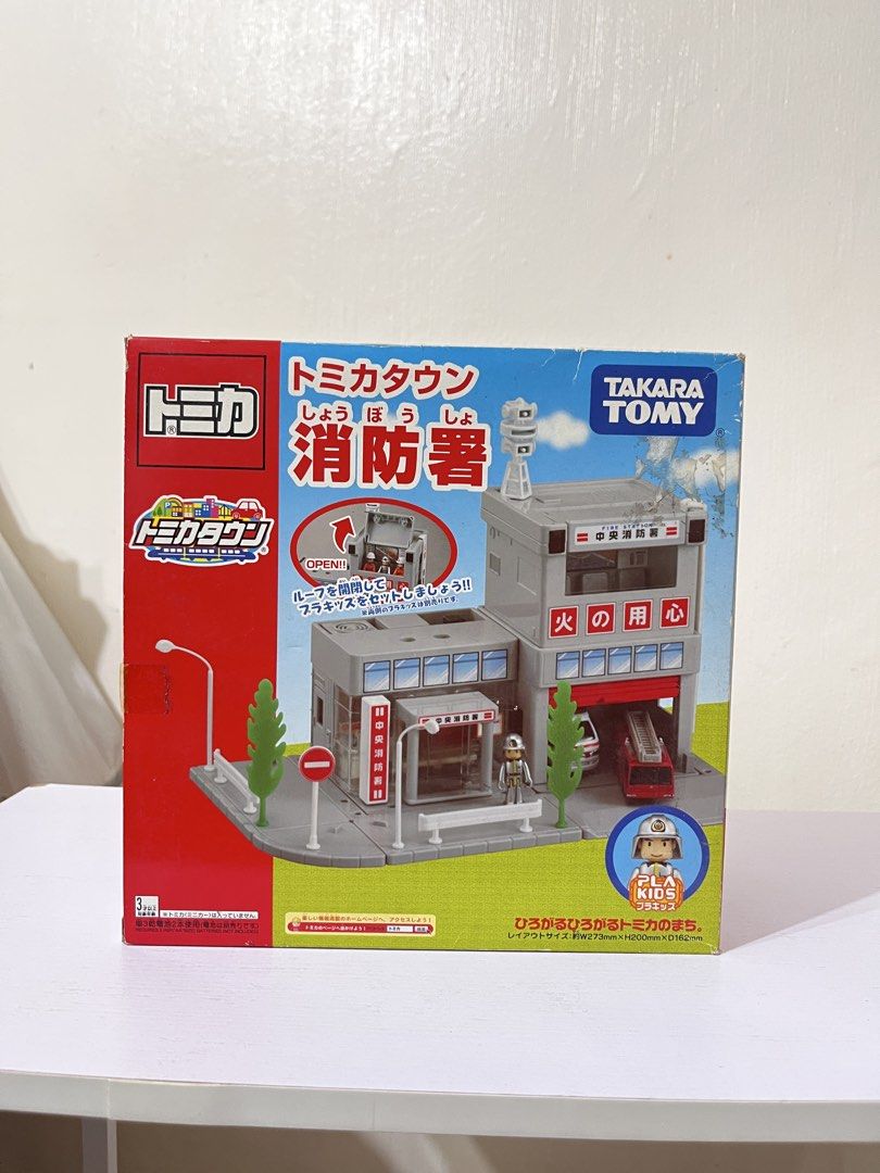 Tomica Town Fire Station Playset (Category: Kids Toys) located in Manila. Submitted by joaqscost (Listing ID 1434240219, Image 1). Description: - Tomica Town Fire Station playset - Features a fire station building - Includes a garage for a fire truck - Comes with a small figure - Includes road accessories - Box shows layout size - Perfect for kids who love fire trucks and city play.